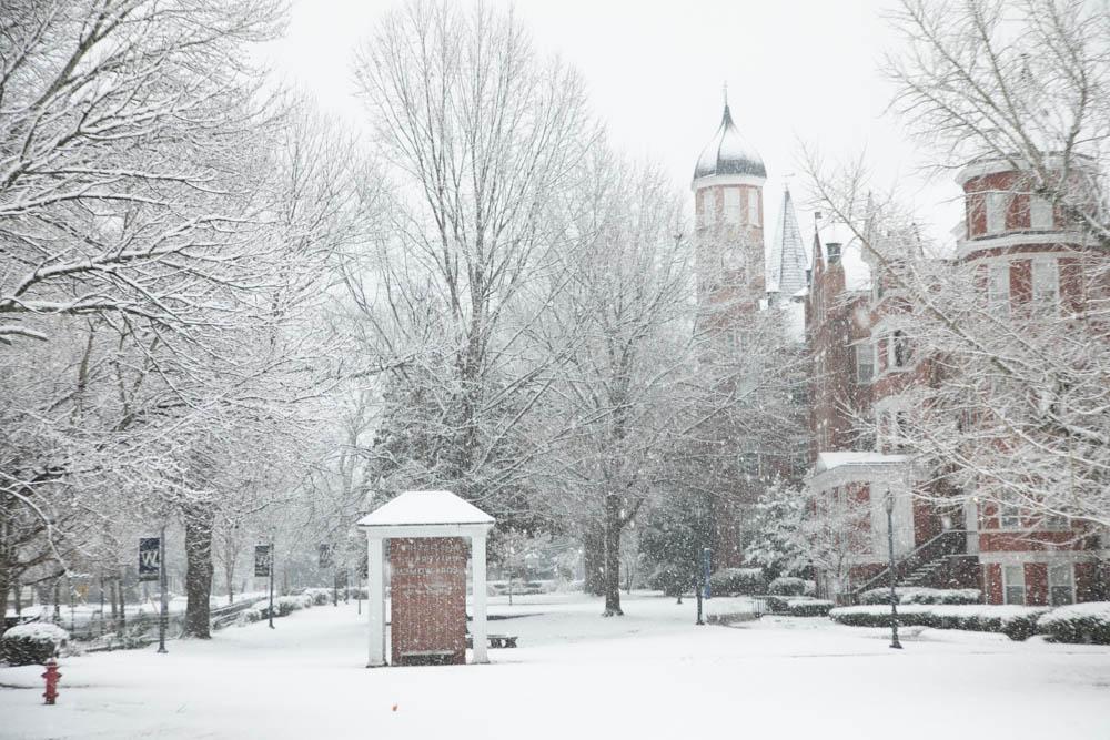 Snow covers the clocktower and front campus