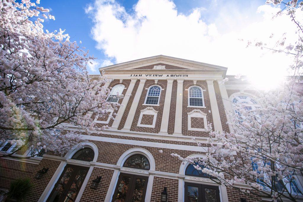 Cherry blossoms bloom in front of Welty Hall