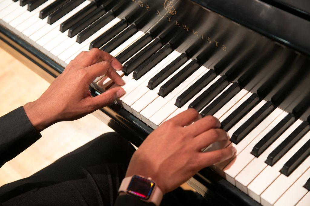 Close up of hands playing a piano