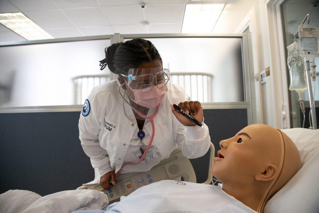 Nursing student works on a simulated patient
