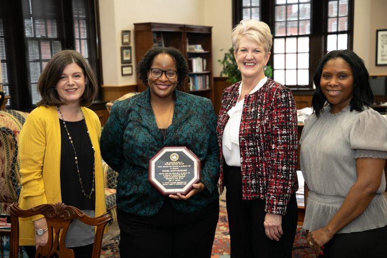 Dr. Shahara'Tova Dente receives the Diversity Educator of the Year award from the President and the chairs of the DEI council.